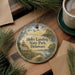 A round ornament with a scenic landscape of Holts Landing State Park, Delaware, featuring a lighthouse, a river, and a bird.