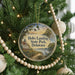 A circular ornament on a Christmas tree, featuring a scenic image of Holts Landing State Park, Delaware.