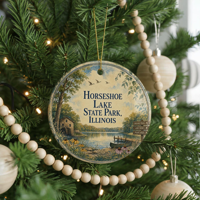 A round ornament hanging on a Christmas tree, featuring a scenic image of Horseshoe Lake State Park, Illinois.