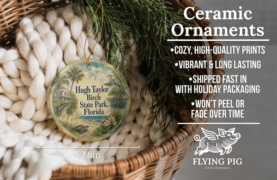 Ceramic ornaments, featuring a round ornament with a tropical beach scene and text, placed in a woven basket with greenery.