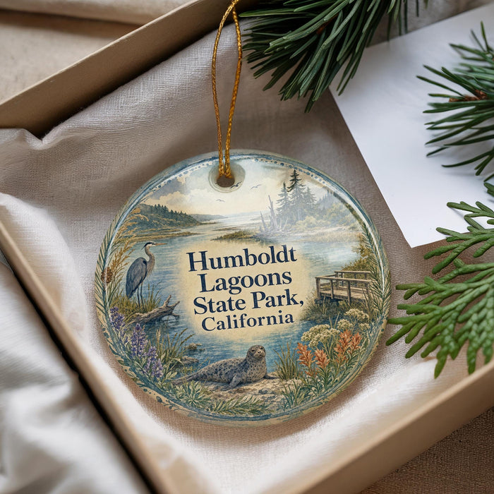 A decorative ornament with a scenic landscape of Humboldt Lagoon State Park, California, featuring a bird, a body of water, and various natural elements.