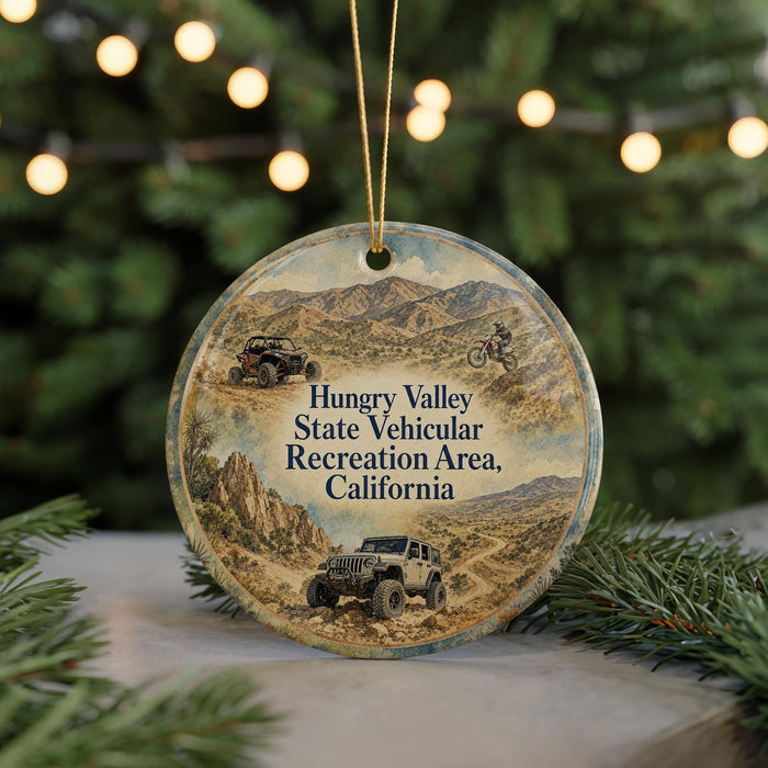 A round ornament featuring a desert landscape with jeeps and mountains, along with text that reads "Hungry Valley State Vehicular Recreation Area, California".