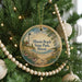 A round ornament hanging on a Christmas tree, featuring a lighthouse and a beach scene with the text "Illinois Beach State Park, Illinois".