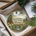A decorative ornament with a scenic landscape of Interlochen State Park, Michigan, featuring a bridge, pine trees, and a river.