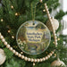 A round ornament on a Christmas tree, featuring a scenic image of Interlochen State Park, Michigan.