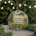 A round ornament with a scenic image of Interlochen State Park, Michigan, hanging from a string.