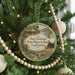 A round ornament hanging on a Christmas tree, featuring an illustration of a house and a typewriter, with the text "Jack London State Historic Park! California" displayed on it.