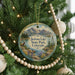 A round ornament hanging on a Christmas tree, featuring a scenic landscape of Jackson Lake State Park, Colorado.