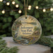 A round ornament with a scenic landscape of Jacksonport State Park, Arkansas, featuring a bird, a cabin, and a river.