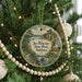 A round ornament hanging on a Christmas tree, featuring a scenic image of Joe Wheeler State Park, Alabama.