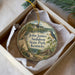 A decorative ornament in a white box, featuring a bird, a house, and a landscape scene, with the text "John James Audubon State Park, Kentucky" printed on it.