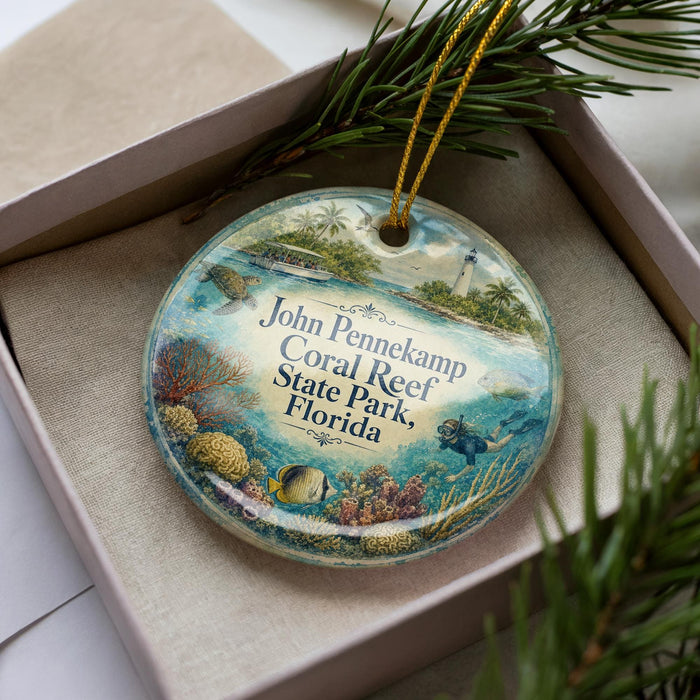 A decorative ornament in a box, featuring an illustration of a tropical beach scene with palm trees, coral reefs, and a lighthouse.