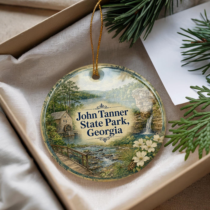 A decorative ornament with a scenic image of John Tanner State Park, Georgia, hanging from a string.