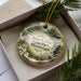 A decorative ornament in a box, featuring a scenic image of John W. Kyle State Park in Mississippi.