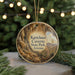 A circular ornament with a scenic image of the Kartchner Caves in Arizona, featuring a desert landscape with a cactus and a mountain range.