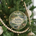 A round ornament hanging on a Christmas tree, featuring a scenic view of Kenlake State Resort Park, Kentucky.