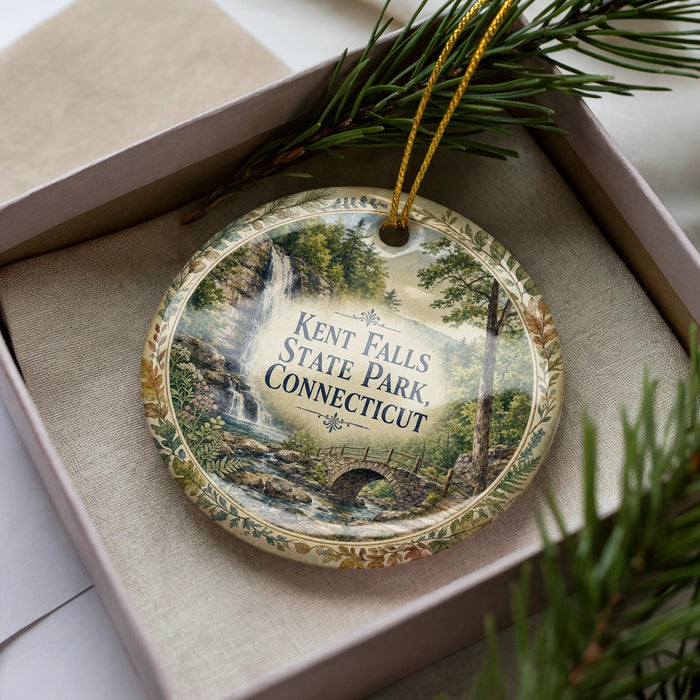 A decorative ornament with a scenic image of Kent Falls State Park in Connecticut, featuring a waterfall and a bridge.