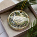A decorative ornament with a scenic image of Kent Falls State Park in Connecticut, featuring a waterfall and a bridge.