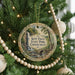A round ornament hanging on a Christmas tree, featuring a scenic image of Kent Falls State Park in Connecticut.