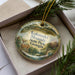 A decorative ornament in a box, featuring a deer and the text "Kolomoki Mounds State Park, Georgia".