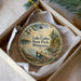 A decorative ornament in a box, featuring a scenic image of Lake Carlos State Park in Minnesota.