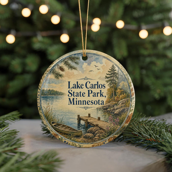 A round ornament with a scenic lake and forest landscape, featuring a boat on the water and a dock in the foreground.