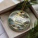 A decorative ornament in a box, featuring a scenic image of Lake Claiborne State Park in Louisiana.