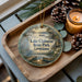A decorative ornament featuring a serene lake scene with a bird, boats, and a dock, along with the text "Lake Claiborne State Park, Louisiana".
