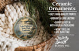 Ceramic ornaments, featuring a lake and state park ornament, are displayed in a basket with pine branches.