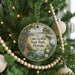 A round ornament hanging on a Christmas tree, featuring a scenic image of Lake Griffin State Park in Florida.