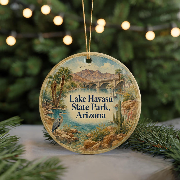 A round ornament with a painting of Lake Havasu State Park, Arizona, featuring a bird, palm trees, and a bridge.