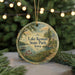 A circular ornament with a scenic landscape of Lake Keomah State Park, Iowa, featuring a lake, a dock, and a forested area.