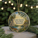 A round ornament with a painting of Lake Louise State Park in Minnesota, featuring a canoe and a scenic landscape.