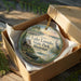 A decorative ornament in a box, featuring a scenic image of Lake Lowndes State Park, Mississippi.