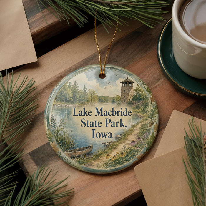A decorative ornament featuring a scenic image of Lake Macbride State Park, Iowa, with a boat on the water and a tower in the background.