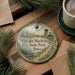 A decorative ornament featuring a scenic image of Lake Macbride State Park, Iowa, with a boat on the water and a tower in the background.