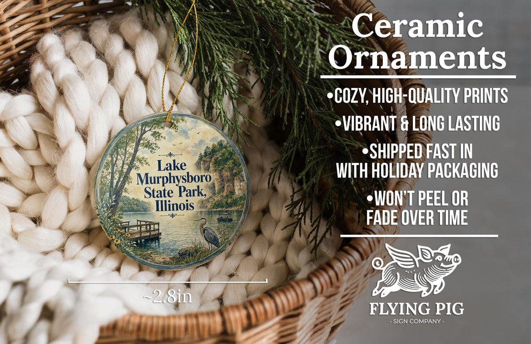 Ceramic ornaments, including a round ornament with a lake, tree, and bird image, are displayed in a basket.