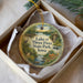 A decorative ornament in a box, featuring a scenic image of Lake of Three Fires State Park, Iowa.