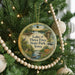A round ornament hanging on a Christmas tree, featuring a scenic image of Lake of Three Fires State Park, Iowa.