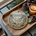 A decorative ornament featuring a scenic landscape of Lake Pueblo State Park, Colorado, with a candle and pine cones on a wooden tray.