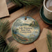A decorative ornament featuring a scenic lake surrounded by pine trees and a castle, with the text "Lake Waramaug State Park, Connecticut" prominently displayed.