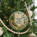 A round ornament hanging on a Christmas tree, featuring a scenic image of Lakelands Trail State Park in Michigan.