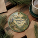 A round ornament with a painting of Lewis and Clark exploring the Missouri River at Lewis and Clark State Park, Iowa.
