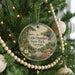A round ornament hanging on a Christmas tree, featuring a scenic image of Little Ocmulgee State Park in Georgia.