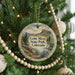 A round ornament hanging on a Christmas tree, featuring a scenic landscape of Lone Mesa State Park, Colorado.