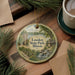 A decorative ornament featuring a scenic landscape of Lowden State Park, Illinois, with a lake, forest, and waterfall.
