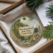 A decorative ornament with a scenic image of the state park, surrounded by greenery and flowers, is displayed in a box.