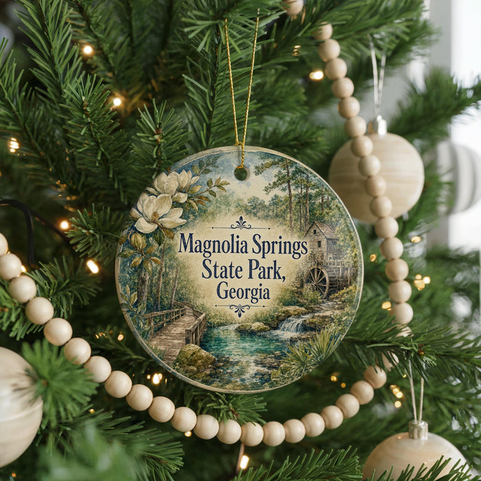 A round ornament hanging on a Christmas tree, featuring a scenic image of Magnolia Springs State Park in Georgia.