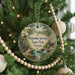 A round ornament hanging on a Christmas tree, featuring a scenic image of Magnolia Springs State Park in Georgia.