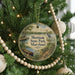 A round ornament hanging on a Christmas tree, featuring a scenic image of Martinak State Park, Maryland.